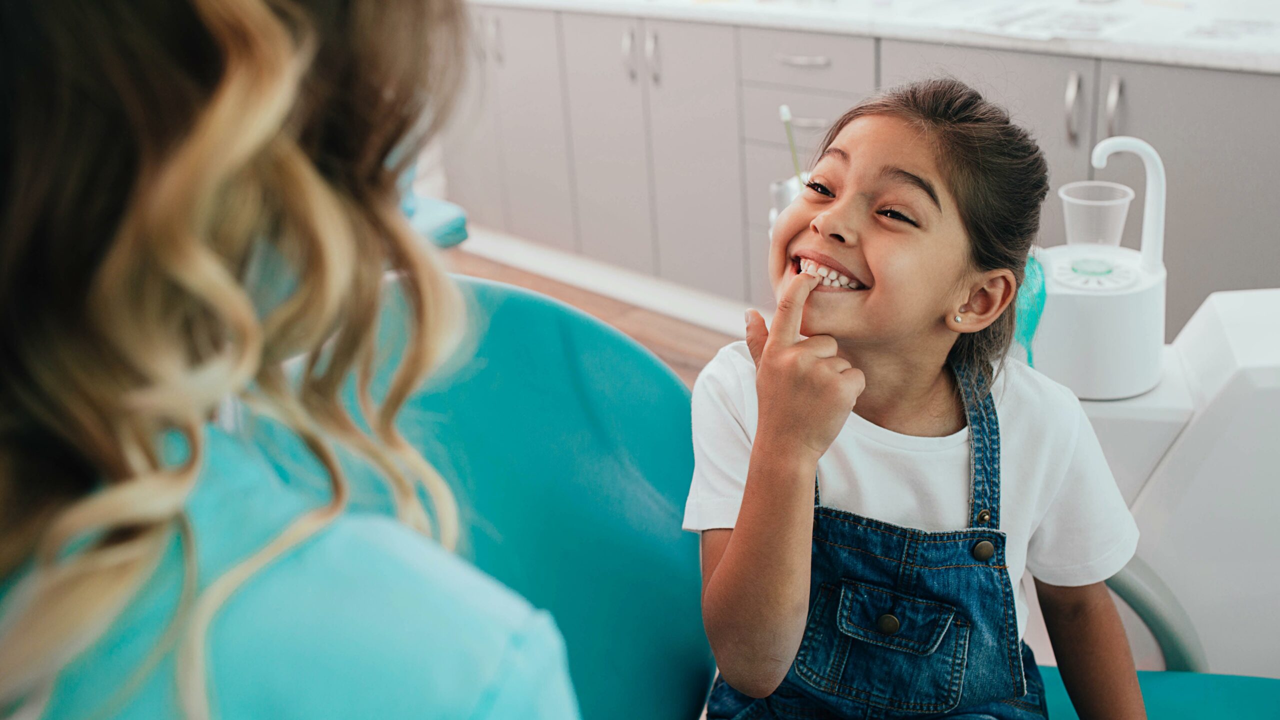 Girl Smiles At Pediatric Dentist