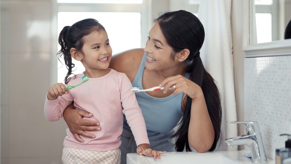 Mom And Child Brush Teeth Together