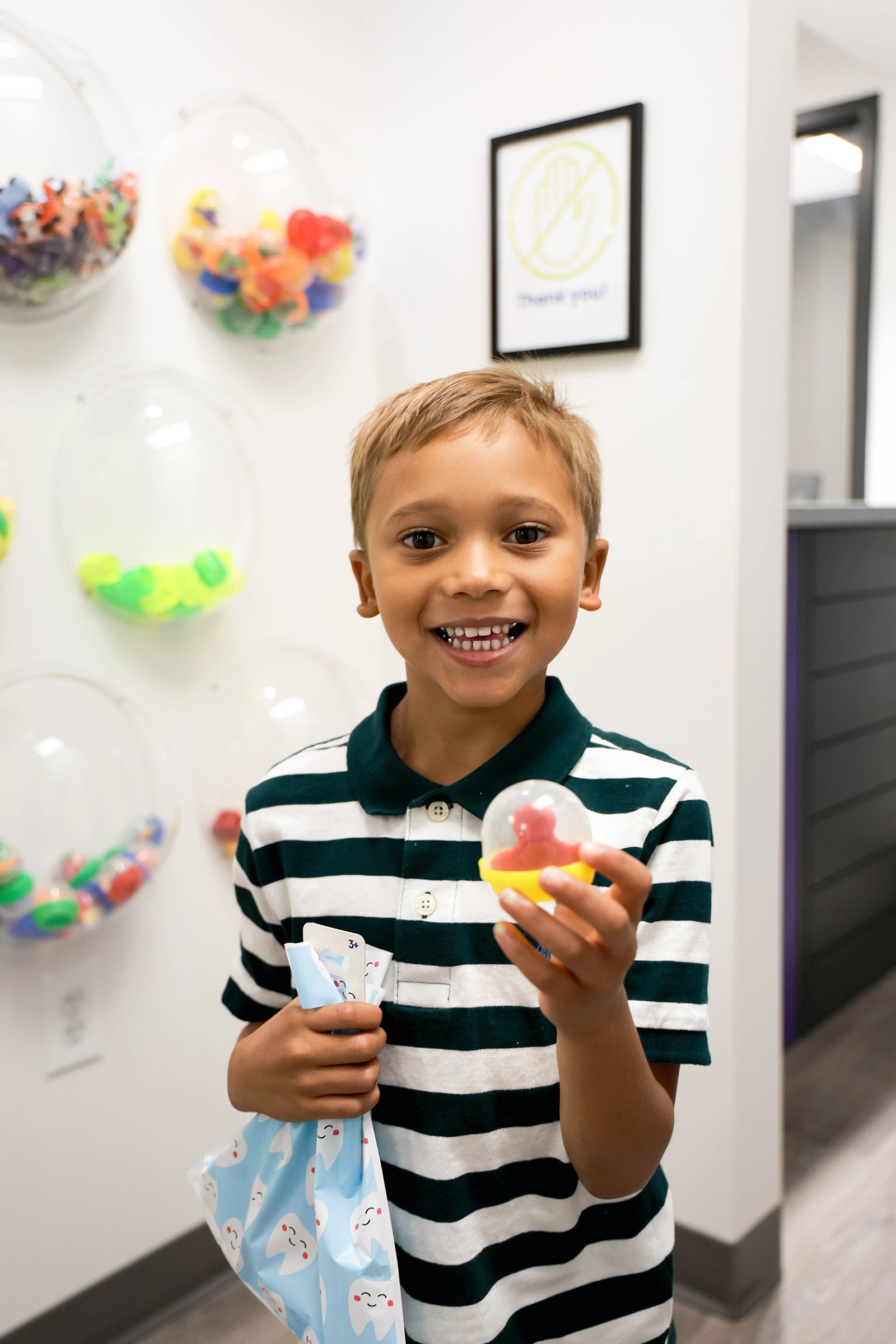 Young dental patient chooses a prize after an appointment